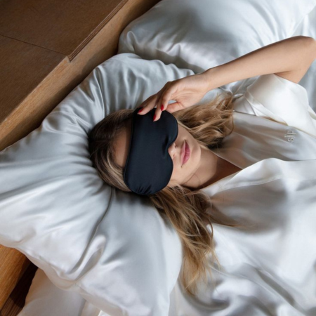 Woman resting on white Sillo silk pillowcases, made from 22-Momme mulberry silk that helps regulate temperature, reduce night sweats, and keep hot sleepers cool and comfortable all night.