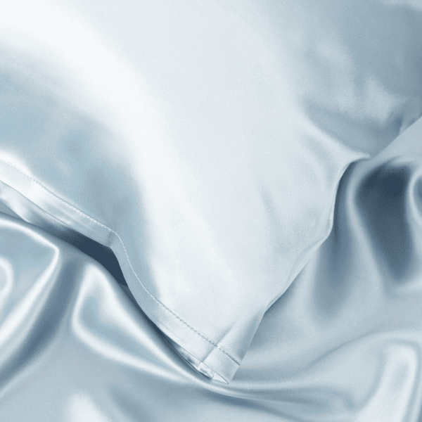 Close-up of Haze Blue Sillo silk pillowcase — 22 Momme 6A grade organic Mulberry silk woven with silver ions for antibacterial protection, showing smooth texture, envelope-style closure, and natural sheen; gentle on skin and hair.