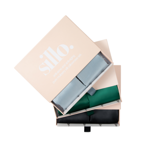 Haze Blue, Emerald Green, and Black Sillo silk pillowcase gift set with Sillo Care Washbag — 22-Momme 6A grade organic Mulberry silk pillowcases in recyclable, eco-friendly packaging for luxury self-care, gifting, and anti-aging skin benefits.