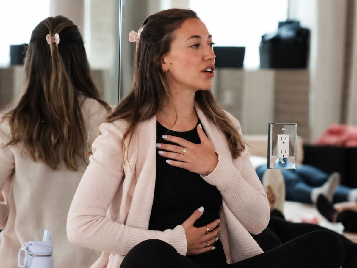 Marianna, a National Board Certified Health and Wellness Coach review on Sillo who sees her Sillo silk pillowcase as an extension of the care she gives her skin and hair, guiding a calming breathing exercise in a bright studio