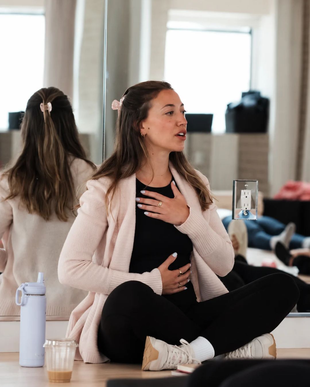 Marianna, a National Board Certified Health and Wellness Coach who sees her Sillo silk pillowcase as an extension of the care she gives her skin and hair, guiding a calming breathing exercise in a bright studio