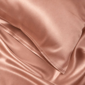 Close-up of Rose Pink Sillo silk pillowcase — 22-Momme 6A grade organic Mulberry silk woven with silver ions for antibacterial protection, showing smooth texture, envelope-style closure, and natural sheen; gentle on skin and hair.