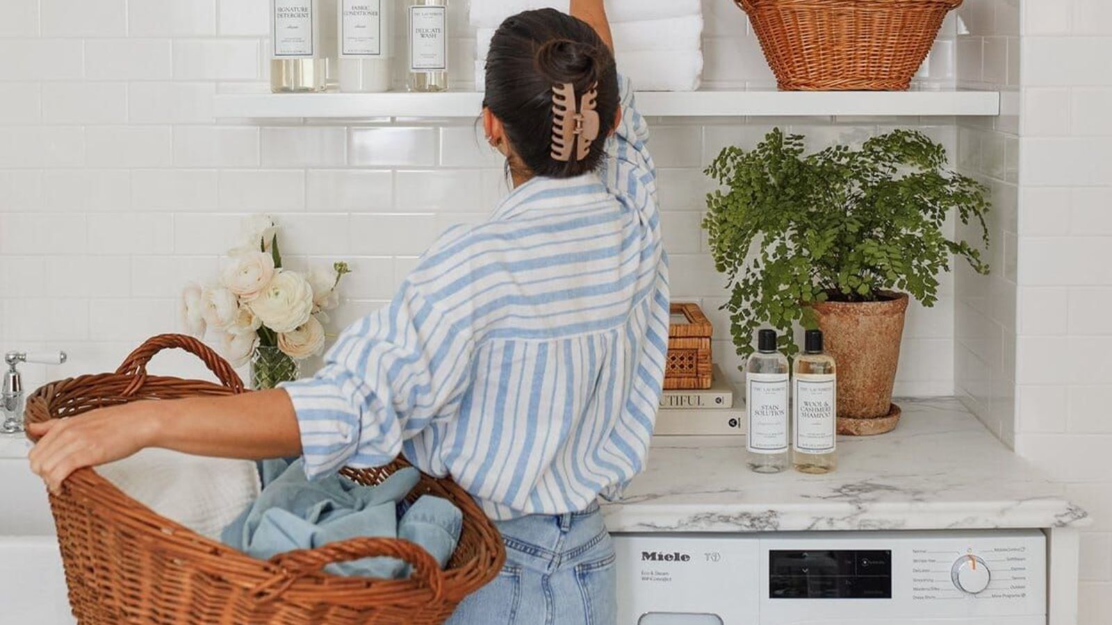 Woman doing laundry with the Sillo Care delicate laundry washbag, protecting her bras and lingerie in the wash
