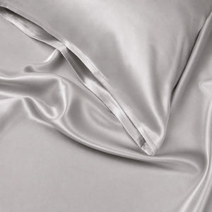 Close-up of Silver Sillo silk pillowcase — 22 Momme 6A grade organic Mulberry silk woven with silver ions for antibacterial protection, showing smooth texture, envelope-style closure, and natural sheen; gentle on skin and hair.