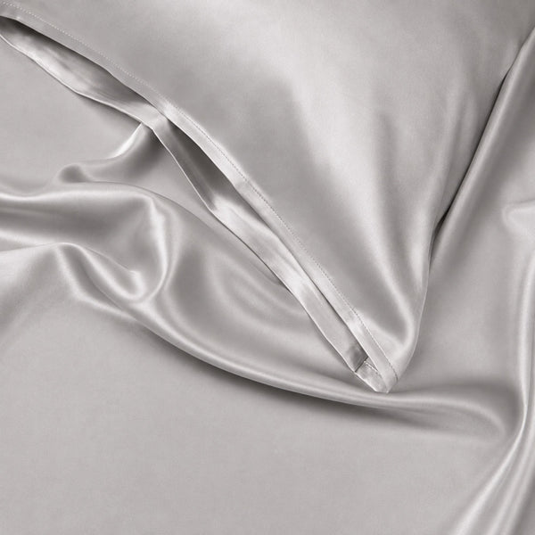 Close-up of Silver Sillo silk pillowcase — 22 Momme 6A grade organic Mulberry silk woven with silver ions for antibacterial protection, showing smooth texture, envelope-style closure, and natural sheen; gentle on skin and hair.