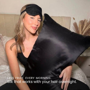 Lifestyle image of woman sleeping on Black Sillo silk pillowcase — smooth, temperature-regulating silk that helps prevent acne, wrinkles, frizz, breakage  while caring for sensitive skin.