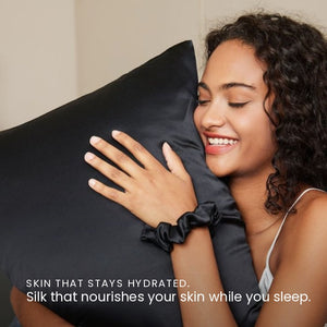 Lifestyle photo of woman holding Black Sillo silk pillowcase — soft 22 Momme organic Mulberry silk woven with silver ions for acne-prone, sensitive skin and hair; helps reduce wrinkles and signs of aging. Cooling, hypoallergenic, and gentle for daily use.