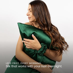 Lifestyle photo of woman holding Emerald Green Sillo silk pillowcase — soft 22-Momme organic Mulberry silk woven with silver ions for acne-prone, sensitive skin and hair; helps reduce wrinkles and signs of aging. Cooling, hypoallergenic, and gentle for daily use.