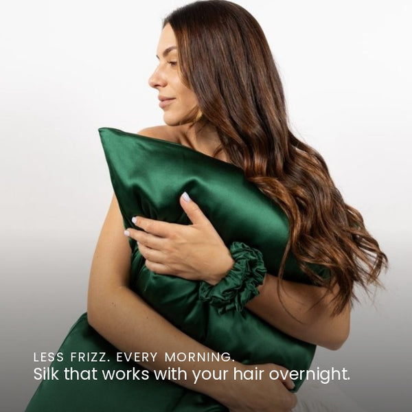 Lifestyle photo of woman holding Emerald Green Sillo silk pillowcase — soft 22-Momme organic Mulberry silk woven with silver ions for acne-prone, sensitive skin and hair; helps reduce wrinkles and signs of aging. Cooling, hypoallergenic, and gentle for daily use.