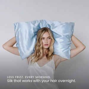Lifestyle photo of woman holding Haze Blue Sillo silk pillowcase — soft 22 Momme organic Mulberry silk woven with silver ions for acne-prone, sensitive skin and hair; helps reduce wrinkles anti-aging. Cooling, hypoallergenic, and gentle for daily use.