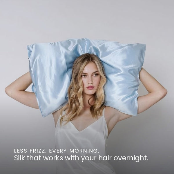 Lifestyle photo of woman holding Haze Blue Sillo silk pillowcase — soft 22 Momme organic Mulberry silk woven with silver ions for acne-prone, sensitive skin and hair; helps reduce wrinkles anti-aging. Cooling, hypoallergenic, and gentle for daily use.
