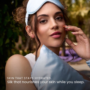 Lifestyle photo of woman holding Haze Blue Sillo silk pillowcase — soft 22-Momme organic Mulberry silk woven with silver ions for acne-prone, sensitive skin and hair; helps reduce wrinkles and signs of aging. Cooling, hypoallergenic, and gentle for daily use.