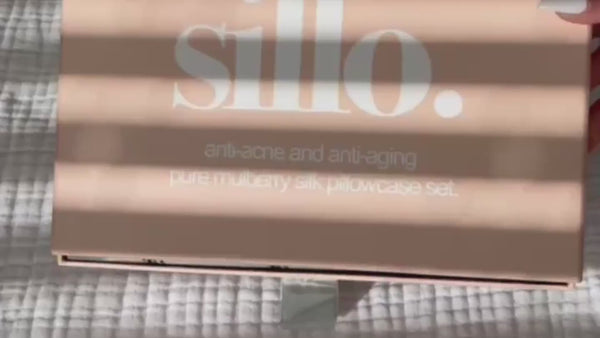 Video showcasing the Sillo silk pillowcase gift set — includes two silver-ion infused, anti-acne 6A-grade 22-Momme mulberry silk pillowcases and a Sillo Care Washbag in recycled packaging; hypoallergenic, sustainable, and designed for clearer skin, smoother hair, and luxurious sleep.