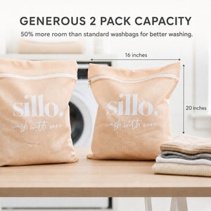 Sillo Care delicate laundry washbags 2 pack on a wooden table with dimension markers showing the spacious 16×20 inch size for washing lingerie, bras, baby clothes, socks, sweaters and activewear, designed to prevent stretching.
