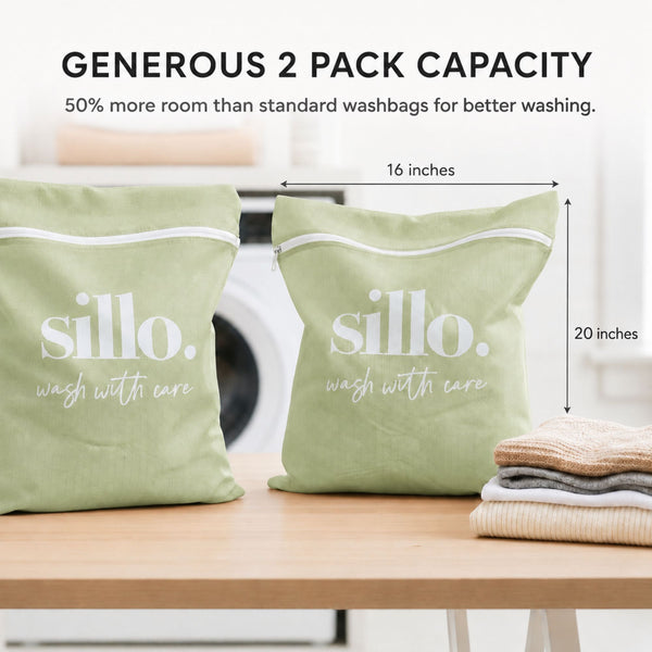 Sillo Care delicate laundry washbags 2 pack in pistachio color on a wooden table with dimension markers showing the spacious 16×20 inch size for washing lingerie, bras, baby clothes, socks, sweaters and activewear, designed to prevent stretching.