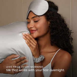 Lifestyle photo of woman holding Silver Sillo silk pillowcase — soft 22 Momme organic Mulberry silk woven with silver ions for acne-prone, sensitive skin and hair; helps reduce wrinkles and signs of aging. Cooling, hypoallergenic, and gentle for daily use.
